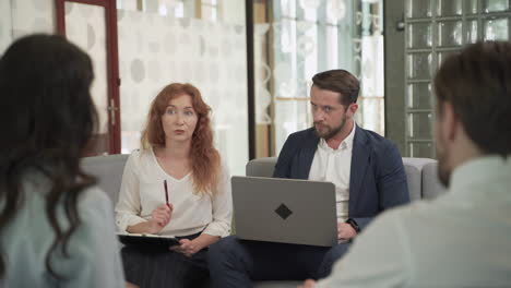 business meeting between two women and two men at an office 1