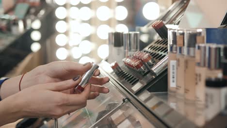 woman shopping for lipstick in a cosmetics store