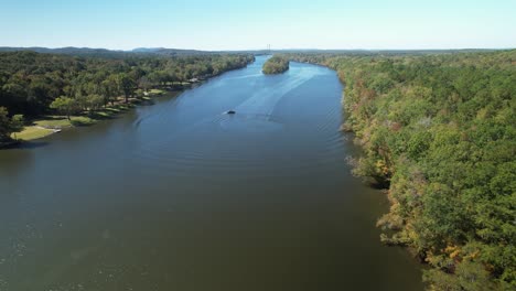 aerial approach of a boat circling in a river