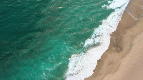 Waves-On-The-Sandy-Shoreline-Of-Beach-During-Golden-Hour