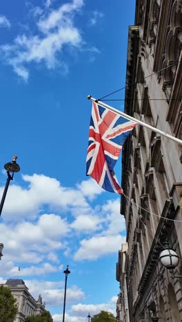 union jack flying high above london building