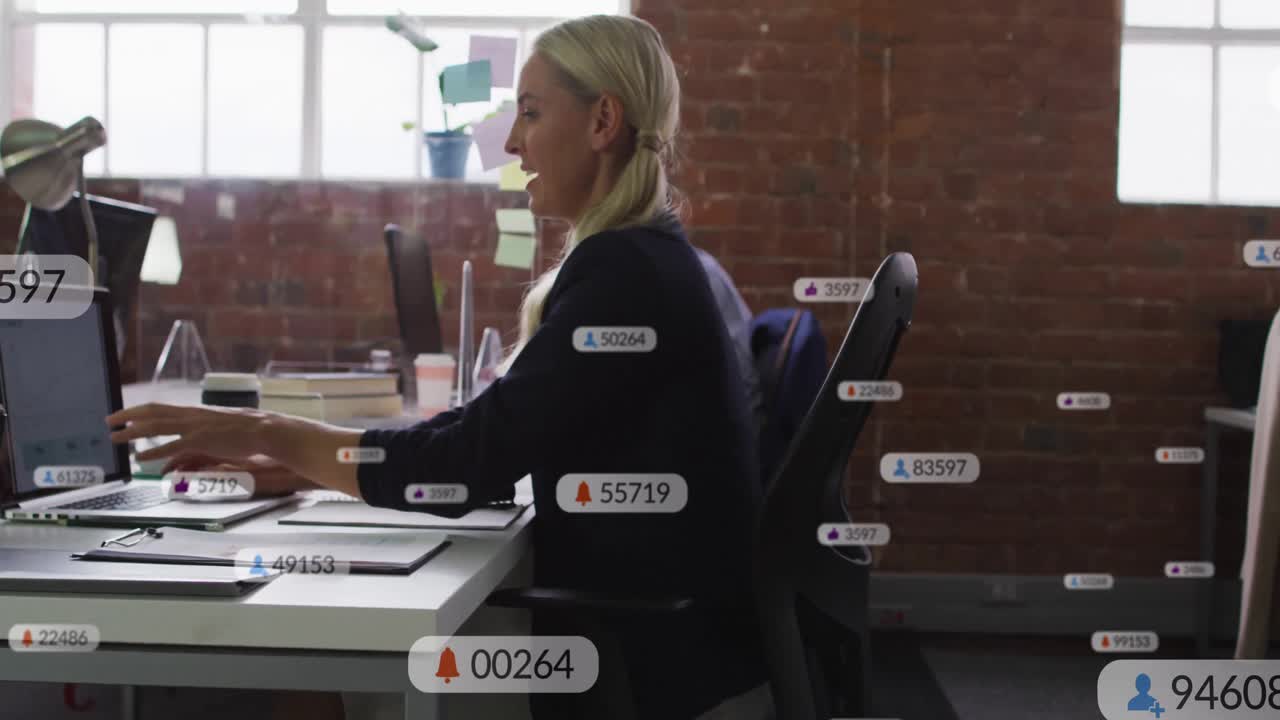 Blonde woman typing laptop generating rising social media notifications and handing binder to peer