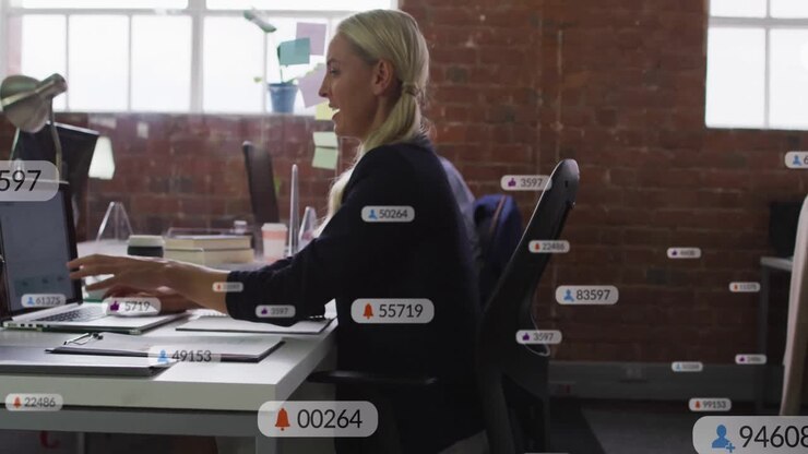 Blonde woman typing laptop generating rising social media notifications and handing binder to peer