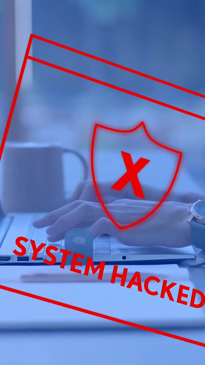 Vertical video: Office IT typing on laptop red glitch sweeping and showing SYSTEM HACKED over keys