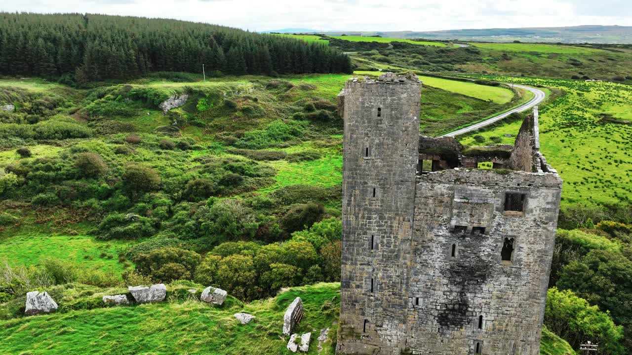Ireland Epic Locations Ballialacken Castle Near Dooolin Co. Clare drone circling impressive Norman castle with Cliffs of Moher in The Background on The Wild Atlantic way