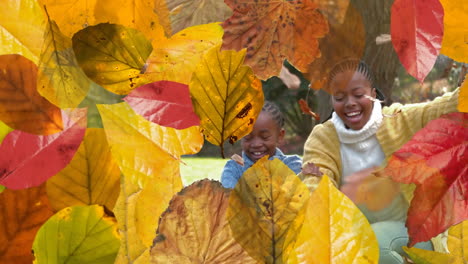 animation of autumn leaves over african american family throwing leaves in park