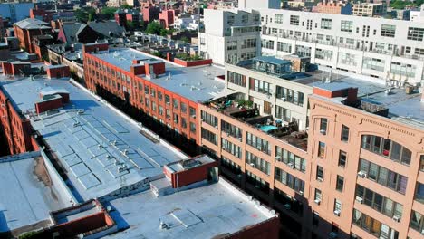 Large-apartment-buildings-in-Brooklyn,-NYC-across-from-Manhattan,-panning-shot