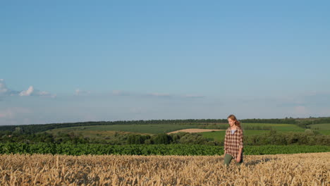 Happy-teenage-girl-runs-through-a-picturesque-wheat-field.-Slow-motion-video