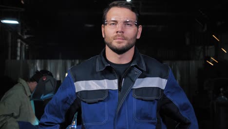 professional confident serious worker at heavy industry factory ready to works