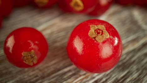 Super-close-macro-of-a-redcurrants-on-a-wooden-table.