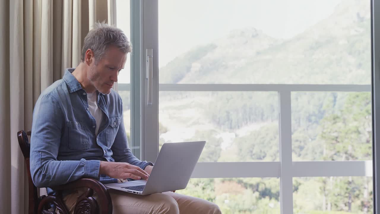 Man using laptop in balcony 4k