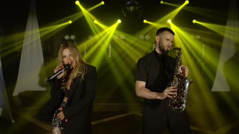 musical band group of two people playing music song, performing on concert musician light stage