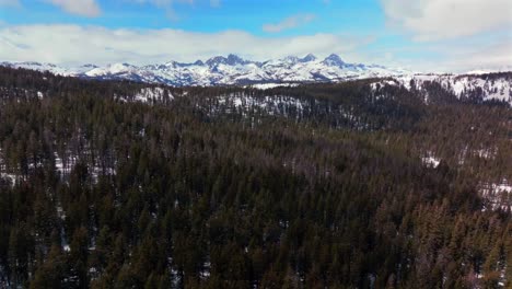 minarets vista point mountain range jagged towering peaks mammoth mountain ski resort aerial drone california winter spring sunny blue sky morning inyo national forest panoramic landscape forward