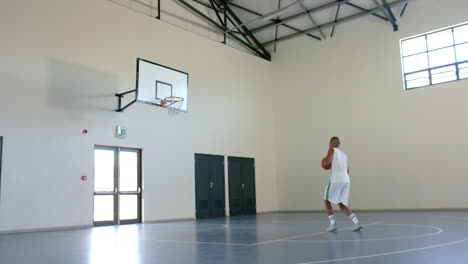 Un-Hombre-Afroamericano-Practica-Baloncesto-En-Un-Gimnasio,-Con-Espacio-Para-Copiar.