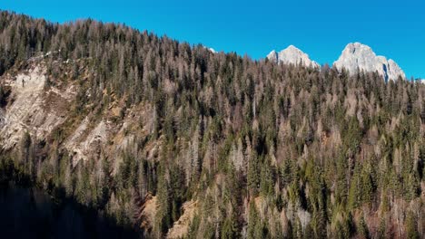 reveal shot of rock formation located at the dolomites mid winter on a sunny day (drone footage)