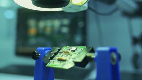 soldering is done on the microchips in the factory with a soldering machine. electronic working hands.1.