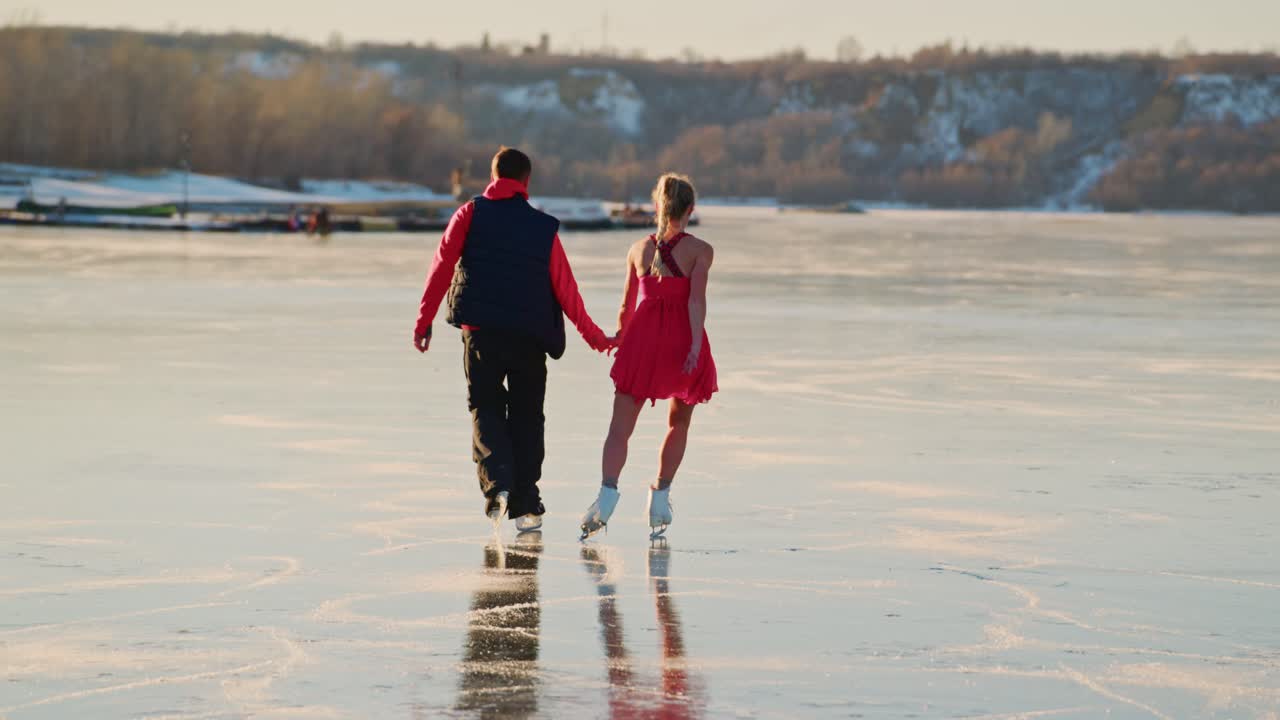 Couple ice skating on a frozen lake