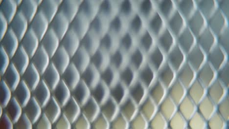 a hyper macro shot of a metal grid, steel pattern, iron industrial texture, aluminum material, super slow motion, full hd 120 fps, smooth zoom out movement, blurry depth of field