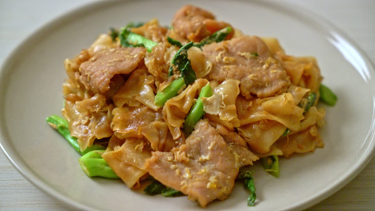 Stir-fried rice noodle with black soy sauce and pork and kale - Asian food style