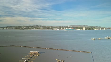 drone views from martinez capture benicia’s scenic shore and the iconic benicia-martinez bridge, with its elegant structure spanning the sparkling waters of the carquinez strait.