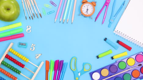 Vibrant back to school tools and stationery make frame for text. Stop motion