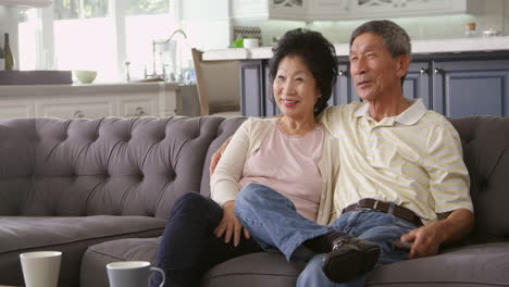 senior asian couple at home on sofa watching tv shot on r3d