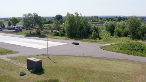 racer driving luxury sports car in the race track - practicing driving skills. - aerial shot