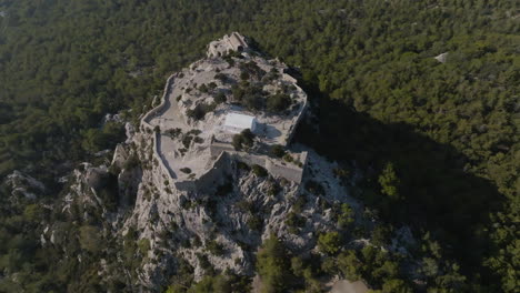 high angle orbit drone shot of the castle of monolithos, in sunny rodos, greece