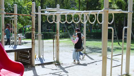 kids enjoying swings at rama 9 park