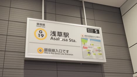 a clear shot of the asakusa station sign for the ginza line, a common sight for tokyo commuters and tourists