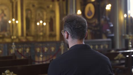 Man-sitting-in-church.