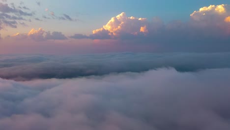 flying over the clouds with the late sun. sunrise or sunset colorful sky background.