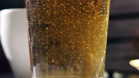 super slow motion capture of bubbling beer in glass