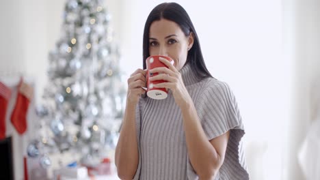 mujer disfrutando de una taza de café de navidad