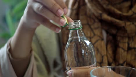 woman opening a bottle of water