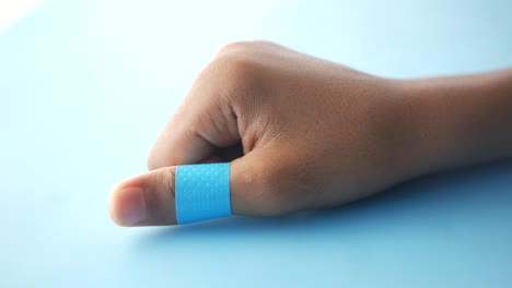 blue  adhesive bandage on hand ,