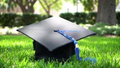 a graduation cap rests on lush green grass, symbolizing academic success and new beginnings. this moment captures the joy and pride of graduates during commencement ceremonies.