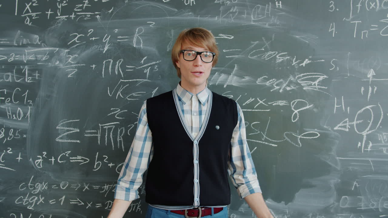 Man explaining math formulas on a chalkboard
