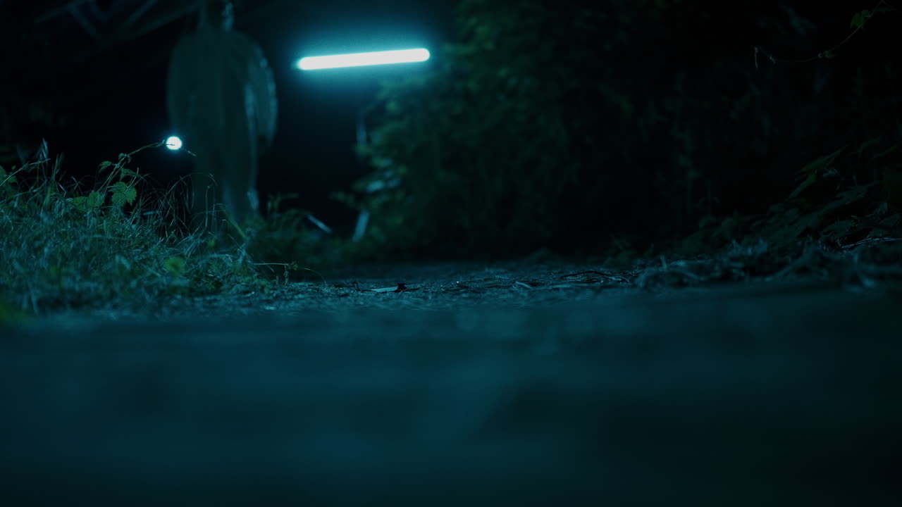 Night Path with Glowing Lights and Person in Protective Suit
