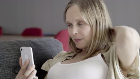 smiling beautiful young woman having video call via smartphone