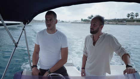 two men boating in a marina