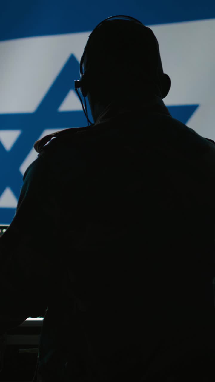 Vertical video Israel Defense Forces dispatcher looking at surveillance transmission