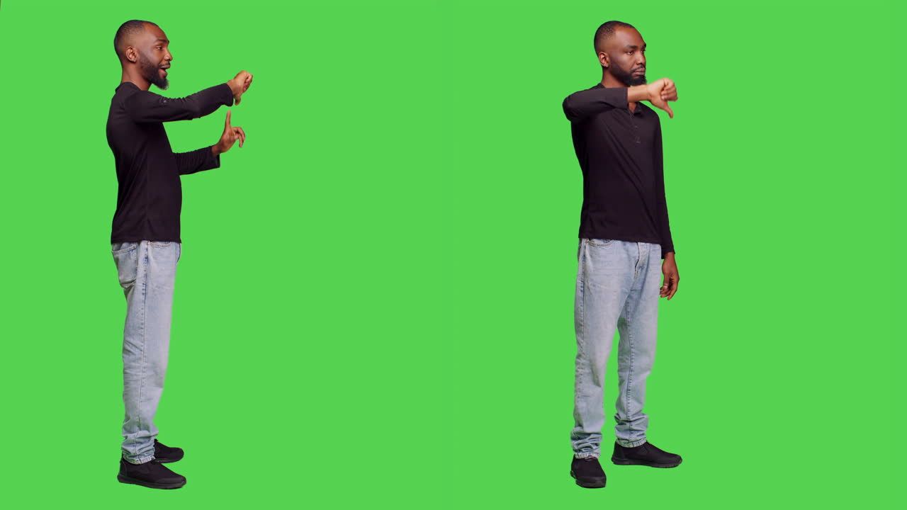Man disapproving with thumbs down gesture on green screen