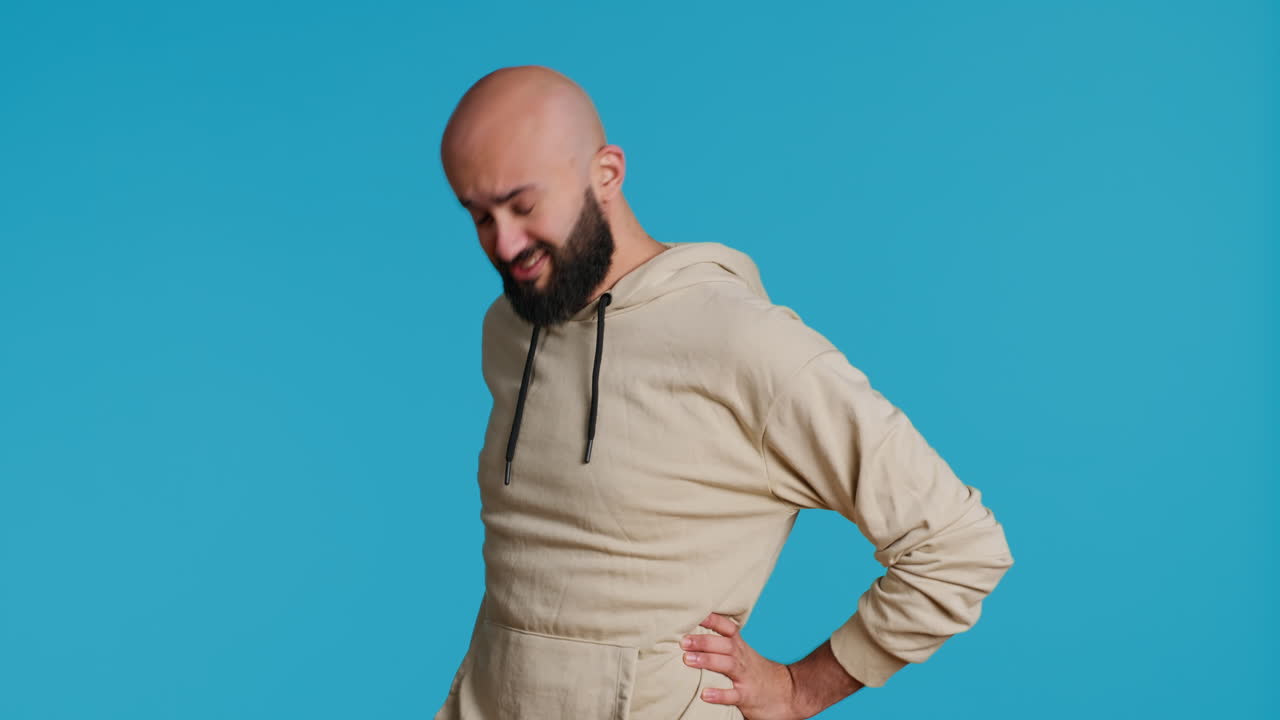 Middle eastern model dealing with lower back pain