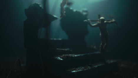 miniature mummified dolls hanging on the gallows at night