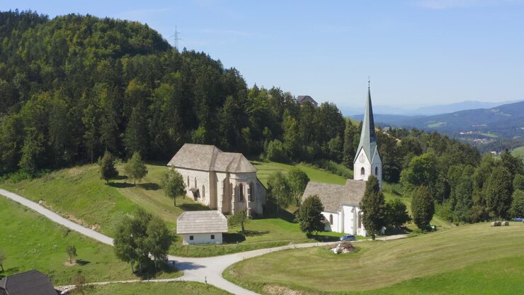 Fly over drone shot of a white monastery at Lese, Slovenia