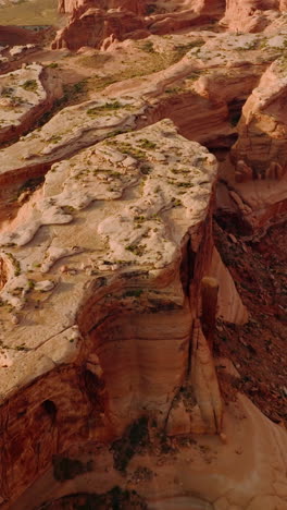 approaching the plain tops of bare canyons in the usa national park. majestic rocks in the deserts of utah from aerial perspective. vertical video