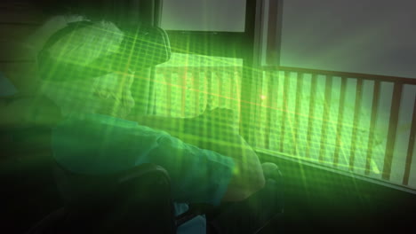 glowing green heart rate monitor against caucasian senior woman on wheelchair wearing vr headset