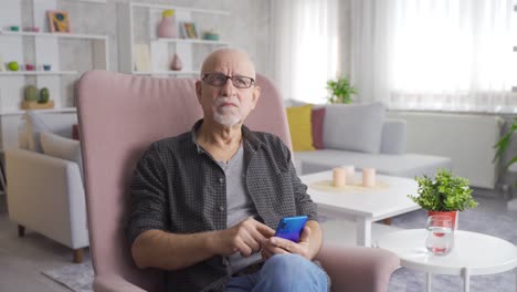 modern old man spends time on the phone at home.
