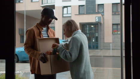 Courier-delivering-box-of-vegetables